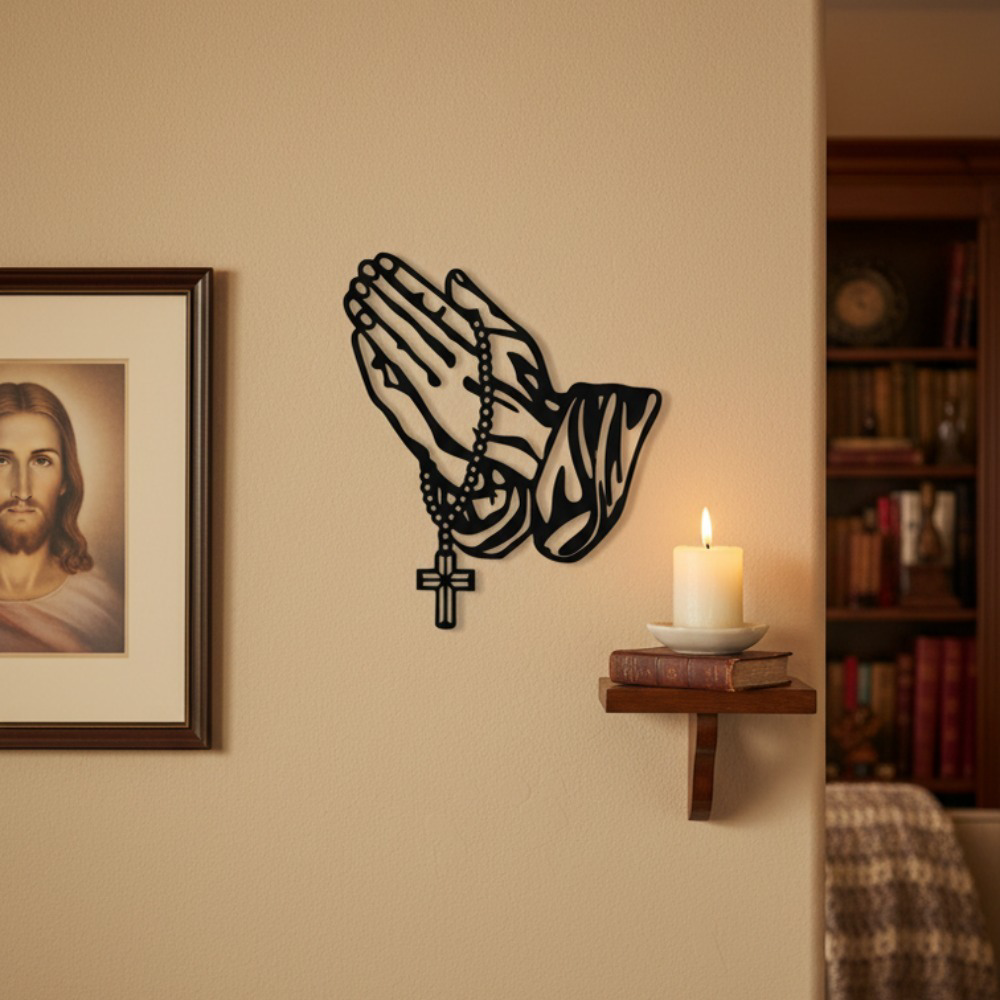 Black metal praying hands with rosary and cross wall art – above shelf